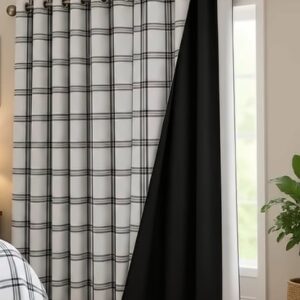 Black and white plaid curtain hung on a metal rod, pulled back to reveal a solid black blackout lining